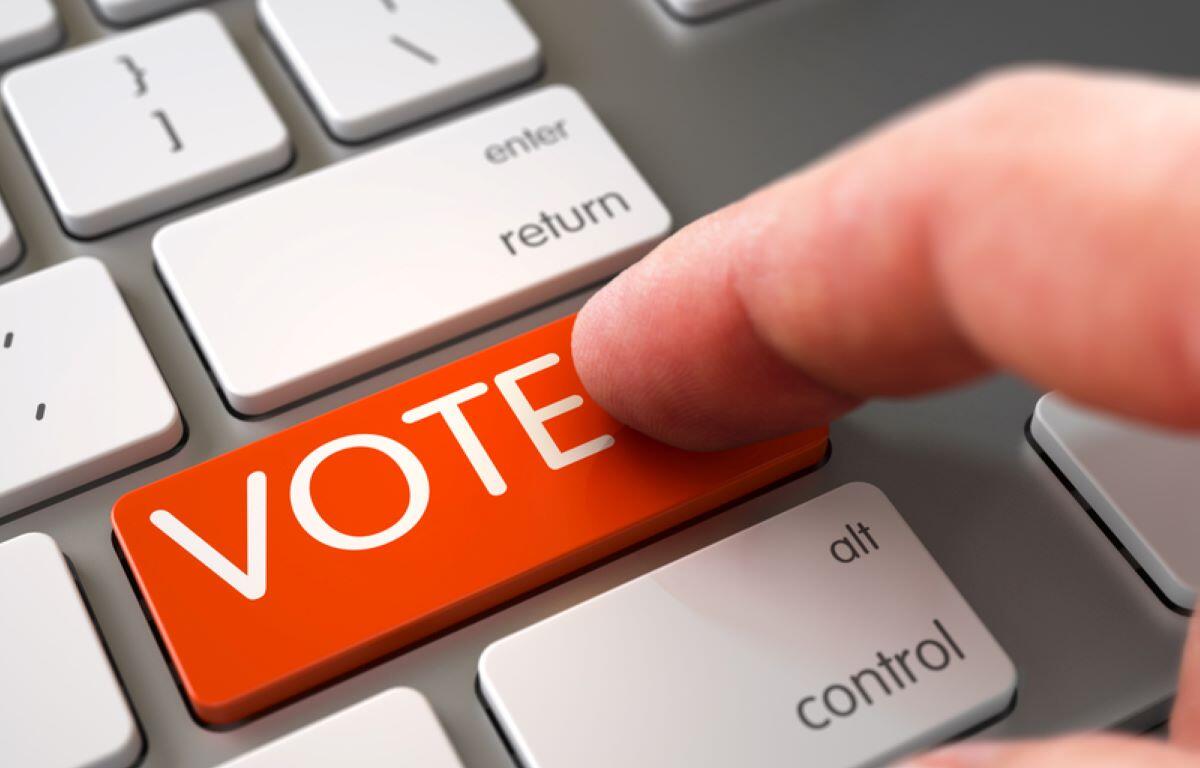 Hand Touching VOTE Key.