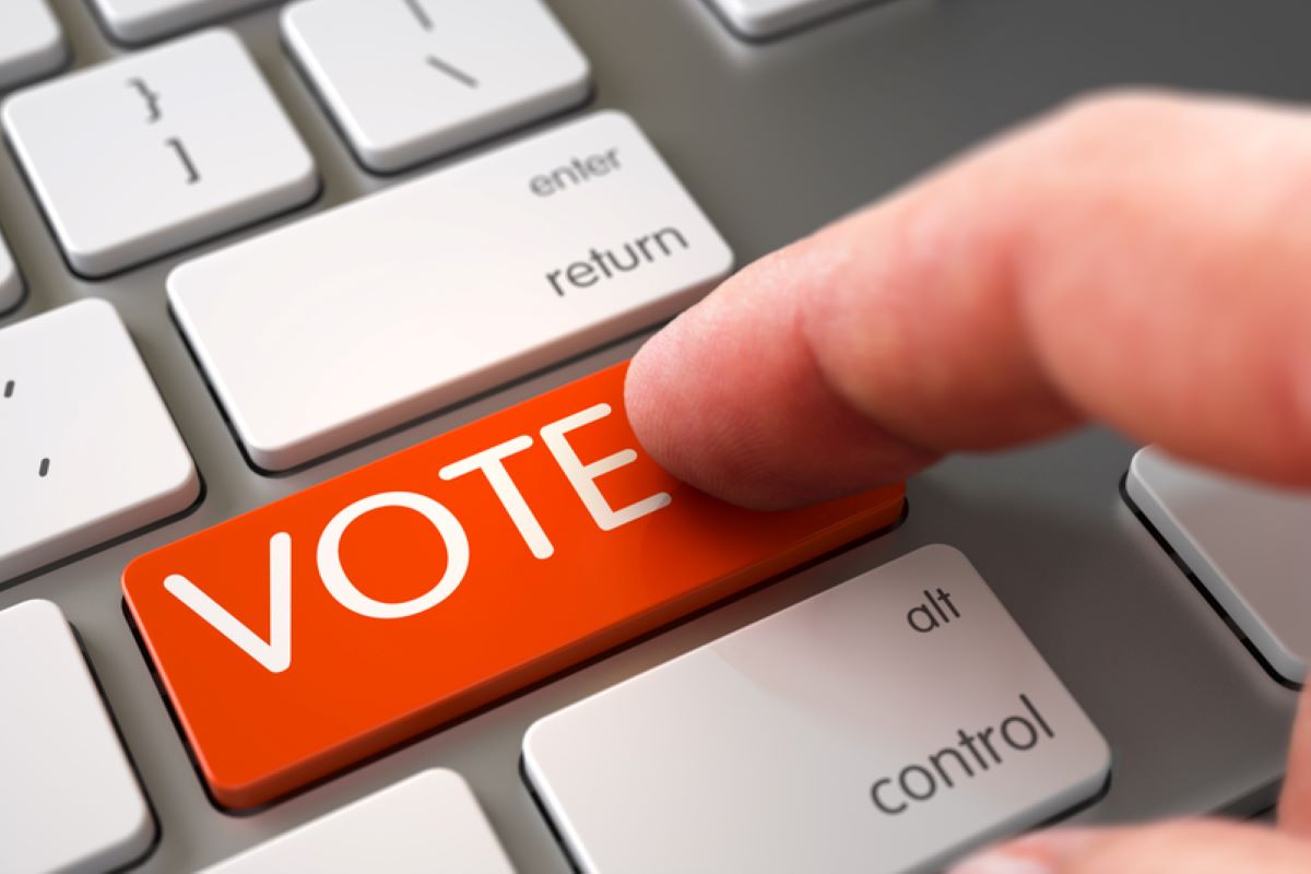 Hand Touching VOTE Key.