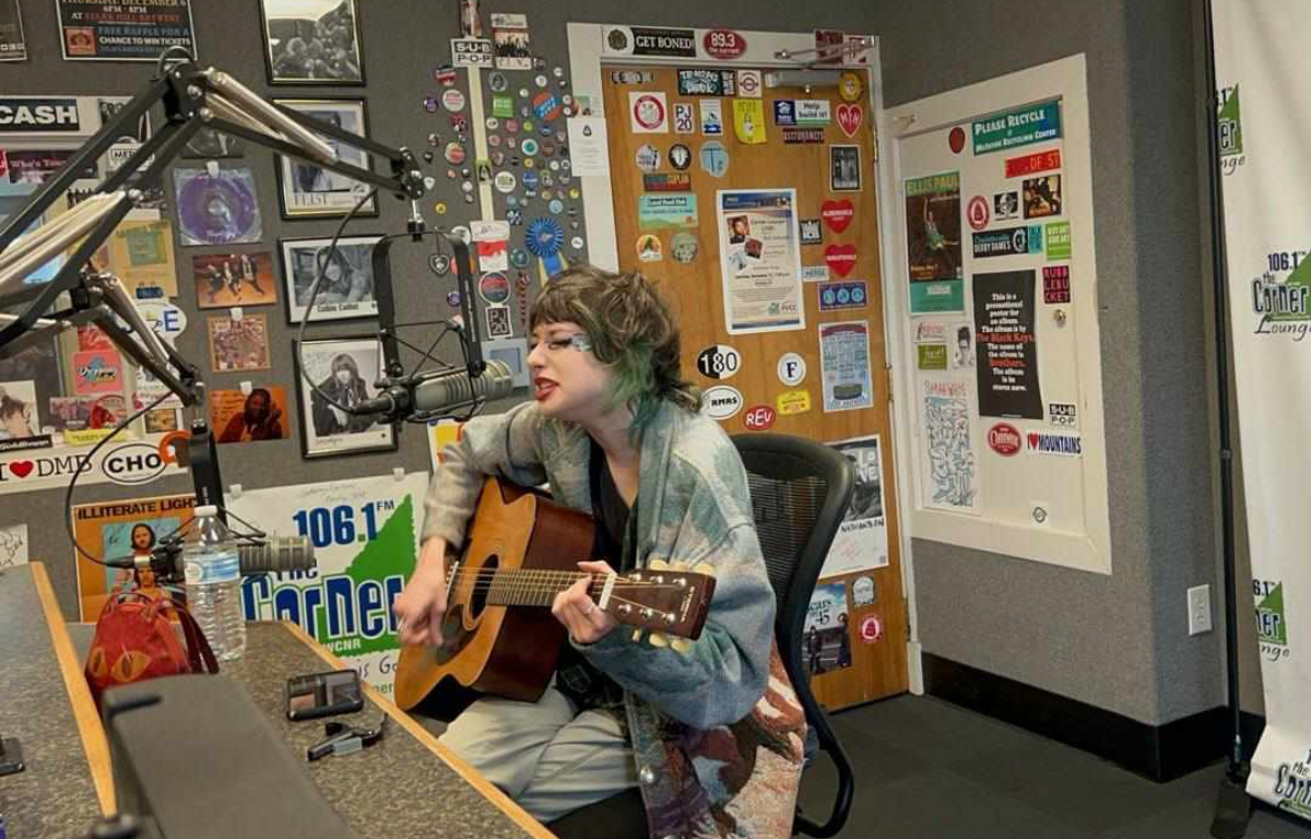 Charlie shea singing into the microphone in the Corner studio.