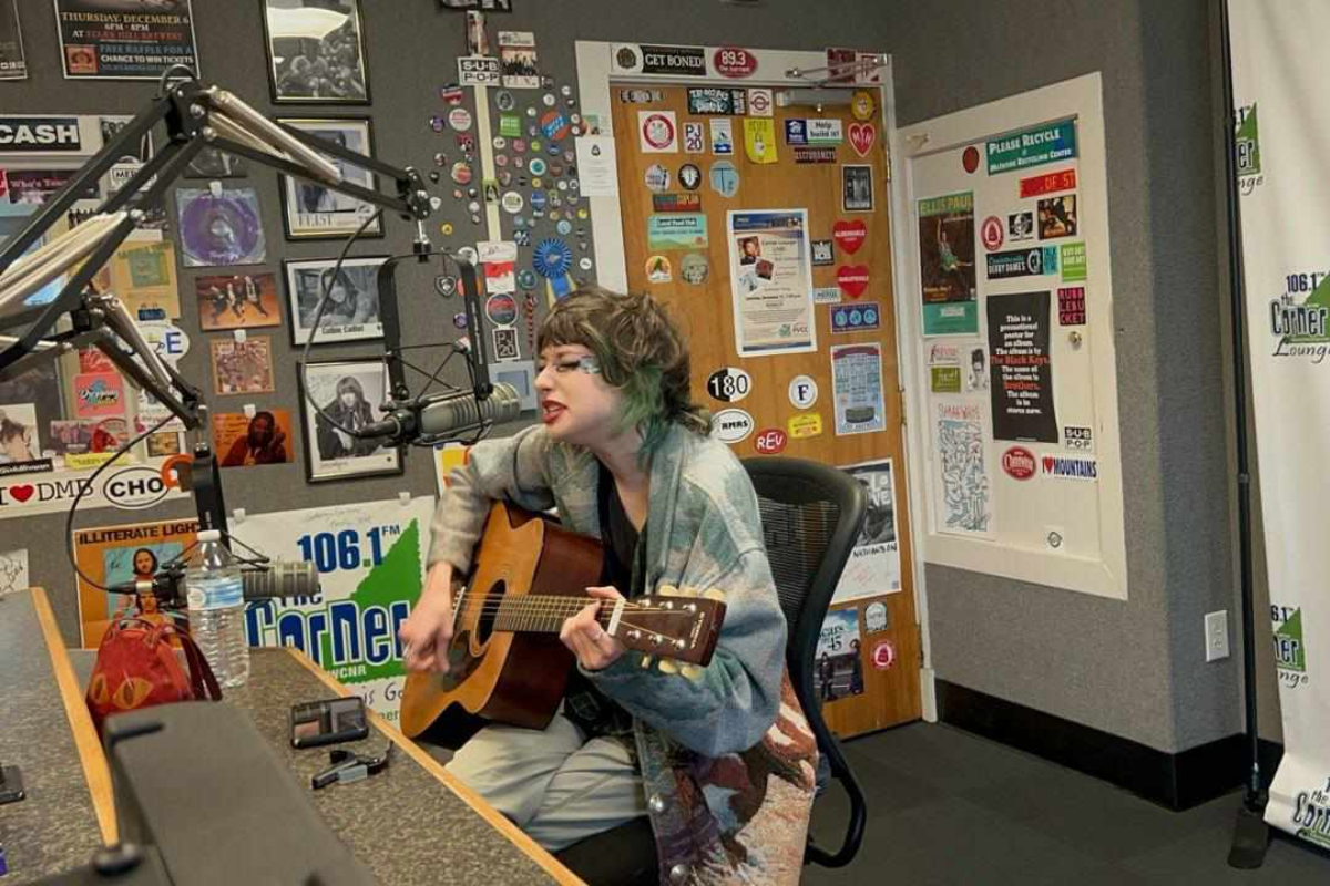 Charlie shea singing into the microphone in the Corner studio.
