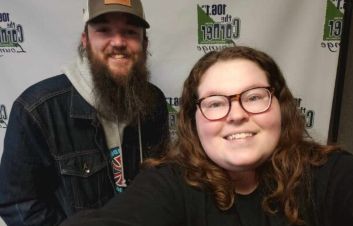 C-Ville Songwriter Anthony Nardone looks into camera and smiles with host Samantha in the Corner studio.