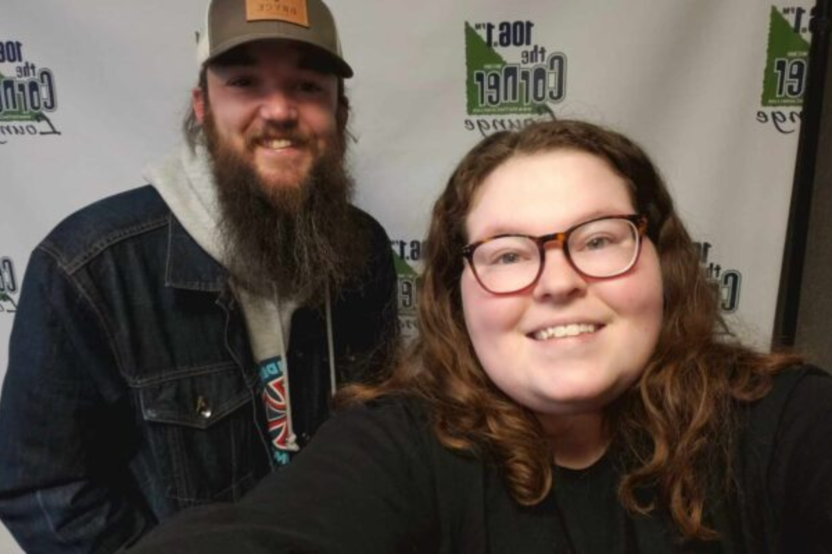 C-Ville Songwriter Anthony Nardone looks into camera and smiles with host Samantha in the Corner studio.