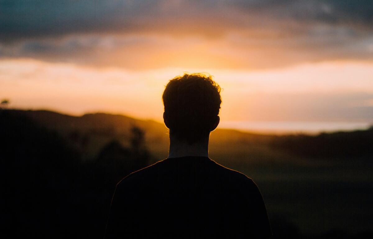 man watching sunset