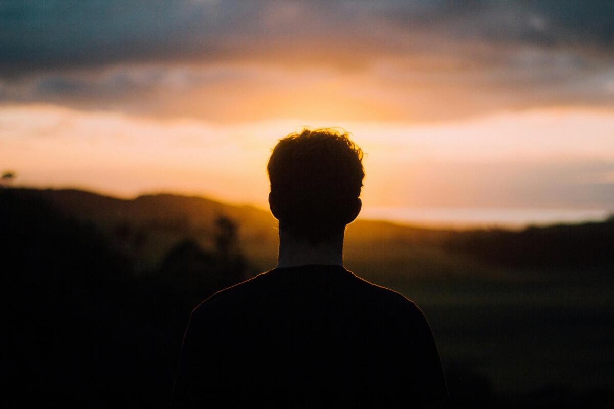 man watching sunset