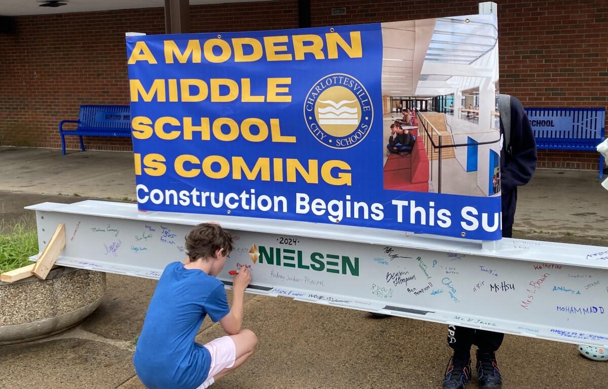 Student signs steel beam