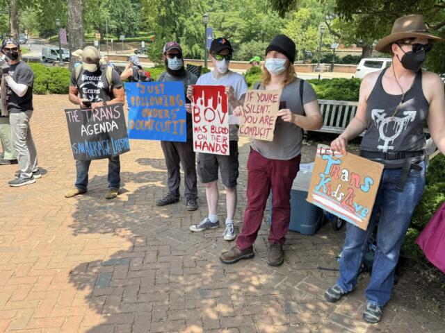 UVA Die In trans protestors carry signs