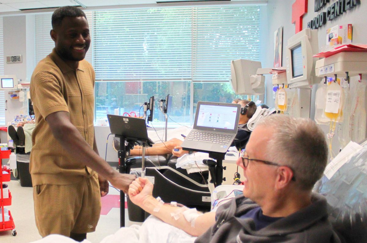 Man donates blood at a Red Cross event