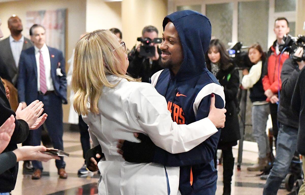 Perris Jones hugs a member of the UL Health team that assisted with his recovery as he is discharged from the hospital.