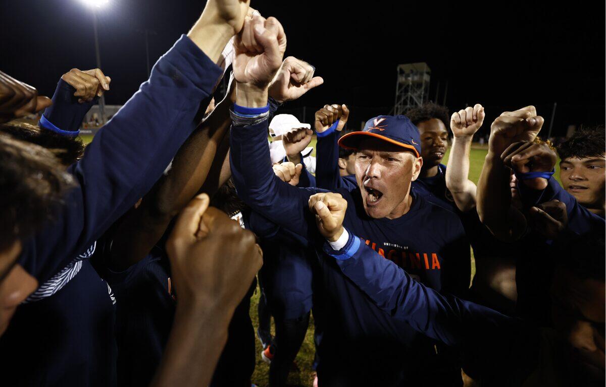 UVA Men's Soccer Head Coach George Gelnovatch cheers with his team after a victory.
