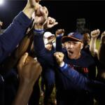 UVA Men's Soccer Head Coach George Gelnovatch cheers with his team after a victory.