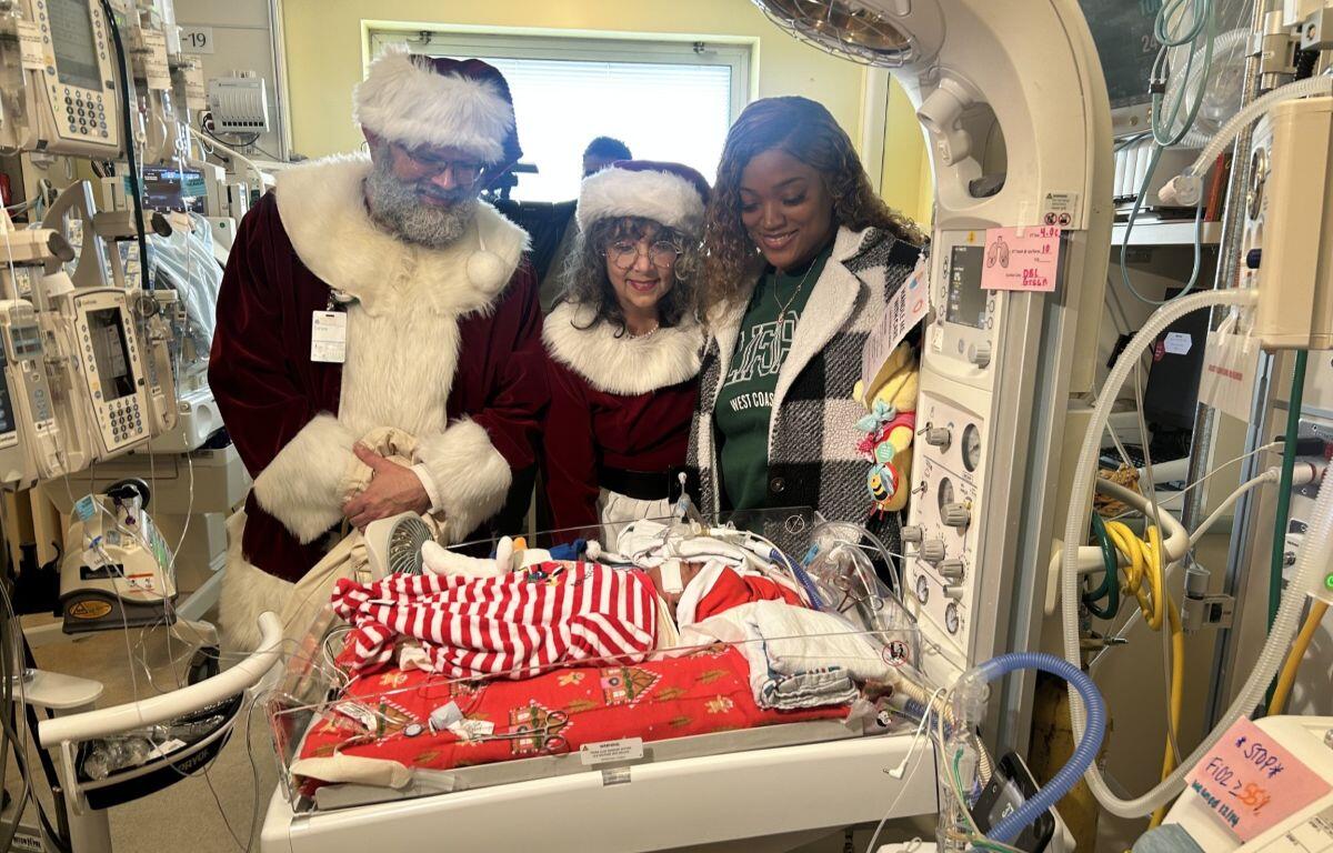 Santa visits a baby in the NICU