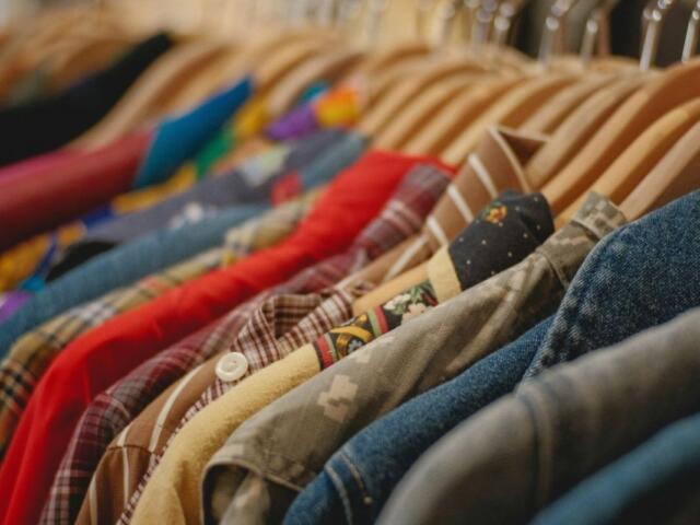 clothes hung on hangers on a rack