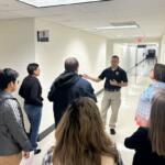 Master officer Joseph George gives a tour to police academy participants.