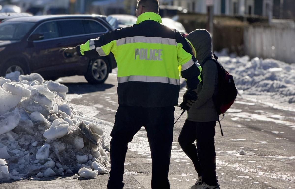 Officer helps student at Rose Hill and Westwood
