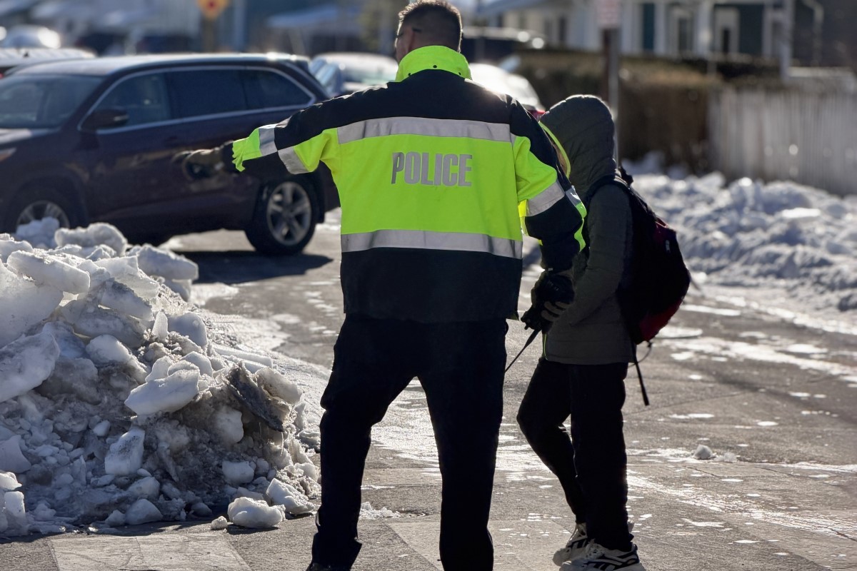 Officer helps student at Rose Hill and Westwood