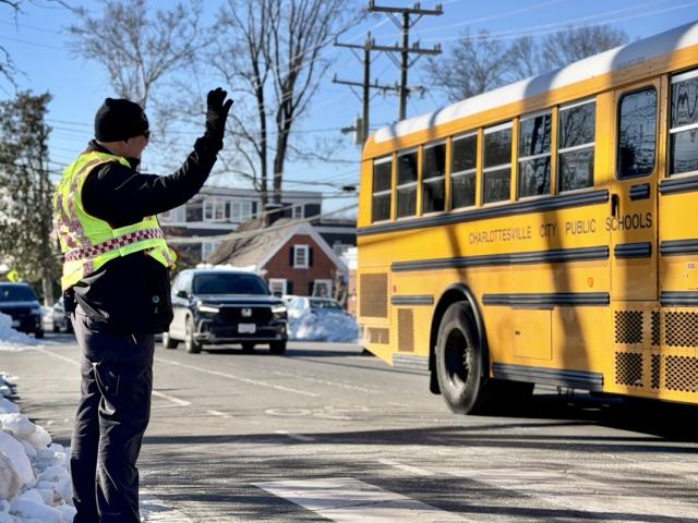 Officer waves at bus at Rose Hill and Westwood