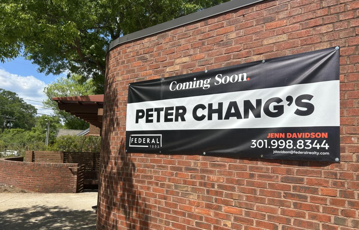 Brick exterior with a large 'Coming Soon' sign advertising Peter Chang's restaurant on a red brick wall.