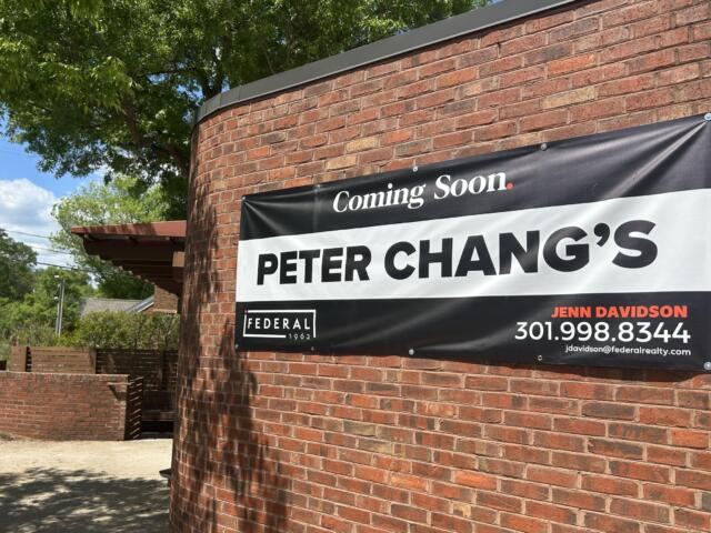 Brick exterior with a large 'Coming Soon' sign advertising Peter Chang's restaurant on a red brick wall.