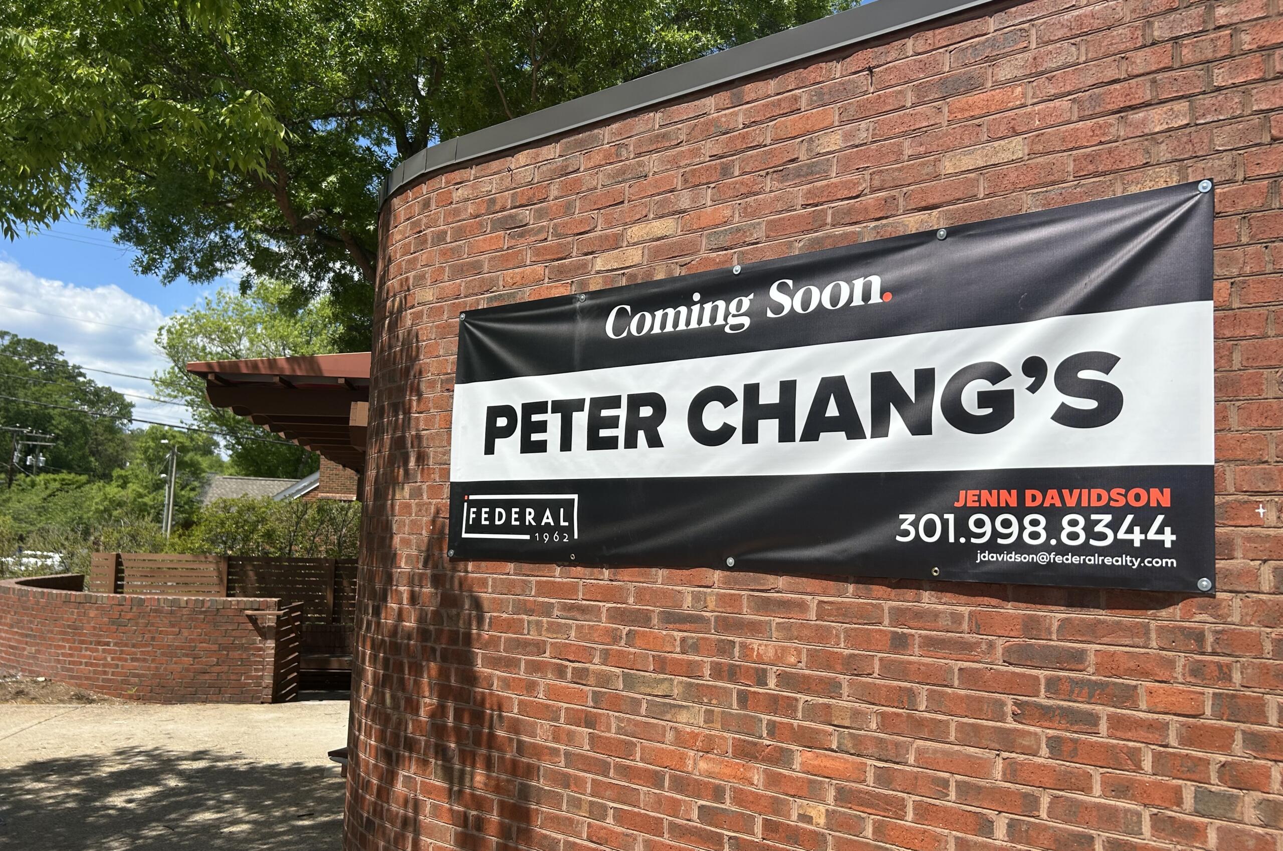 Brick exterior with a large 'Coming Soon' sign advertising Peter Chang's restaurant on a red brick wall.