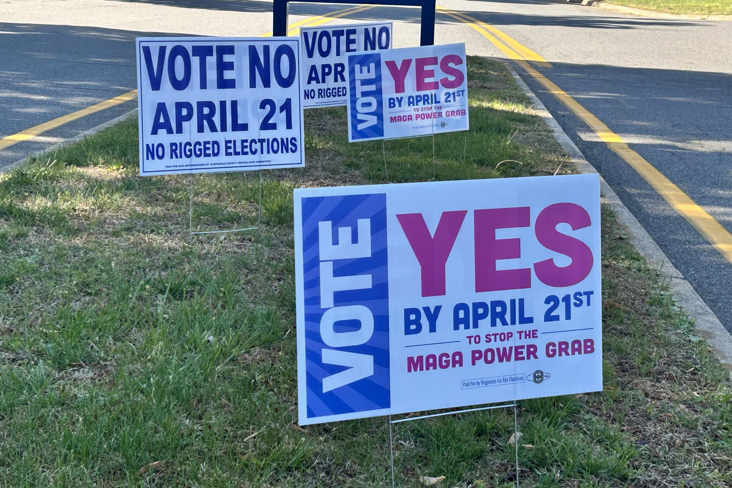 Campaign signs on a grassy roadside urging votes for April 21, some say 'Vote No' and others 'Yes' in bold letters.