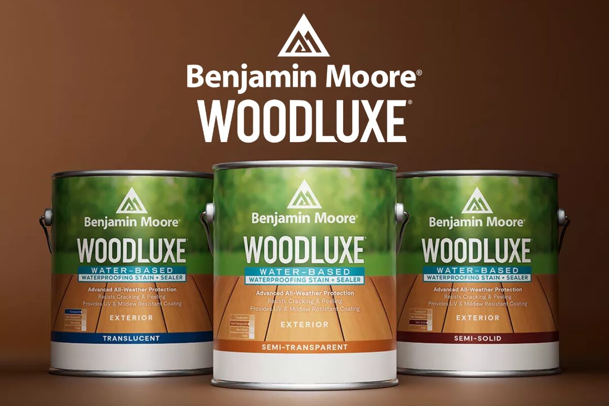 Three Benjamin Moore WoodLuxe paint cans in front of a brown backdrop, with a white WoodLuxe logo on top.