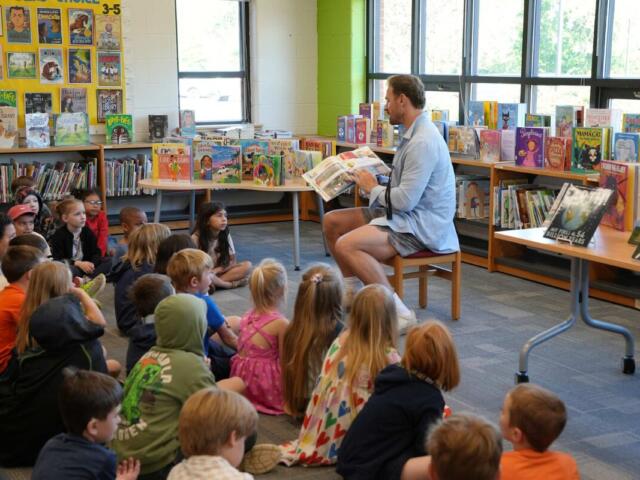 Chris Long reading to Scottsville Elementary School students, May 2026