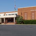 Front entrance of Buffalo Gap High School: brick facade, flagpole, and steps under a covered porte-cochere.