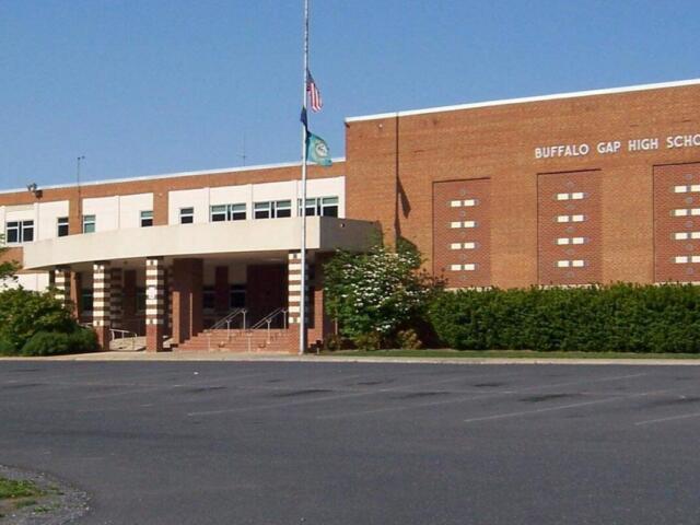 Front entrance of Buffalo Gap High School: brick facade, flagpole, and steps under a covered porte-cochere.