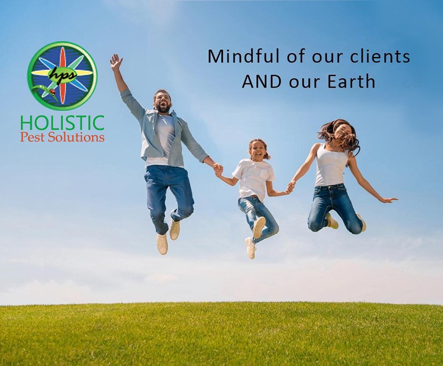Family of three jumping in the air on a grassy hill with Holistic Pest Solutions logo on the left and the slogan 'Mindful of our clients AND our Earth' on the sky background.