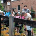 Master Gardners help kids at Orange club set up garden.
