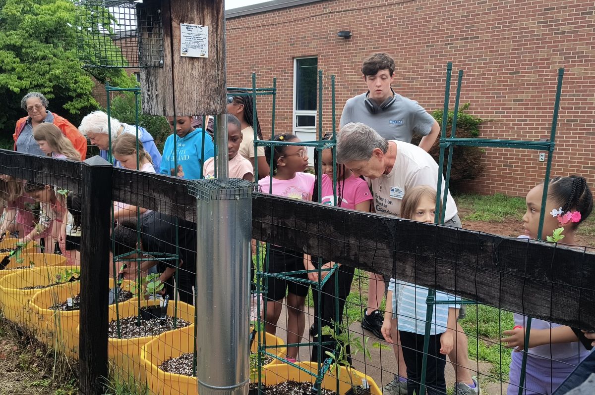 Master Gardners help kids at Orange club set up garden.