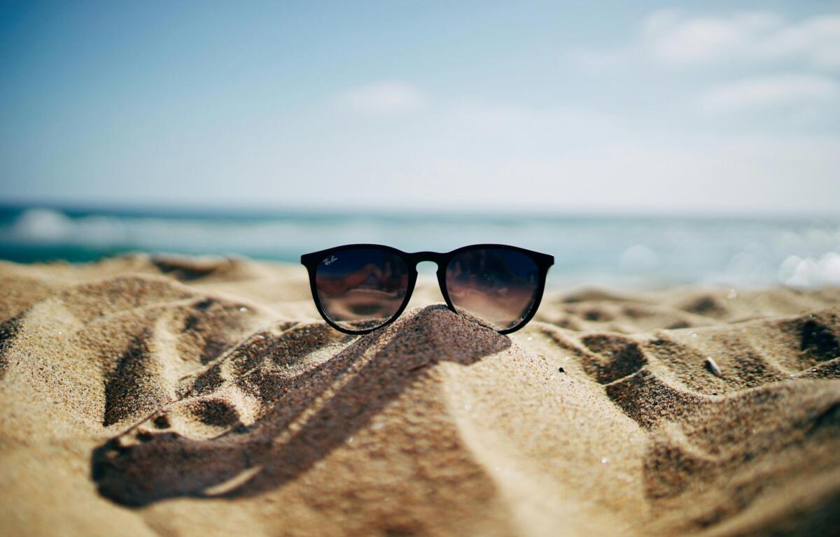 sunglasses on a sand hill at the beach