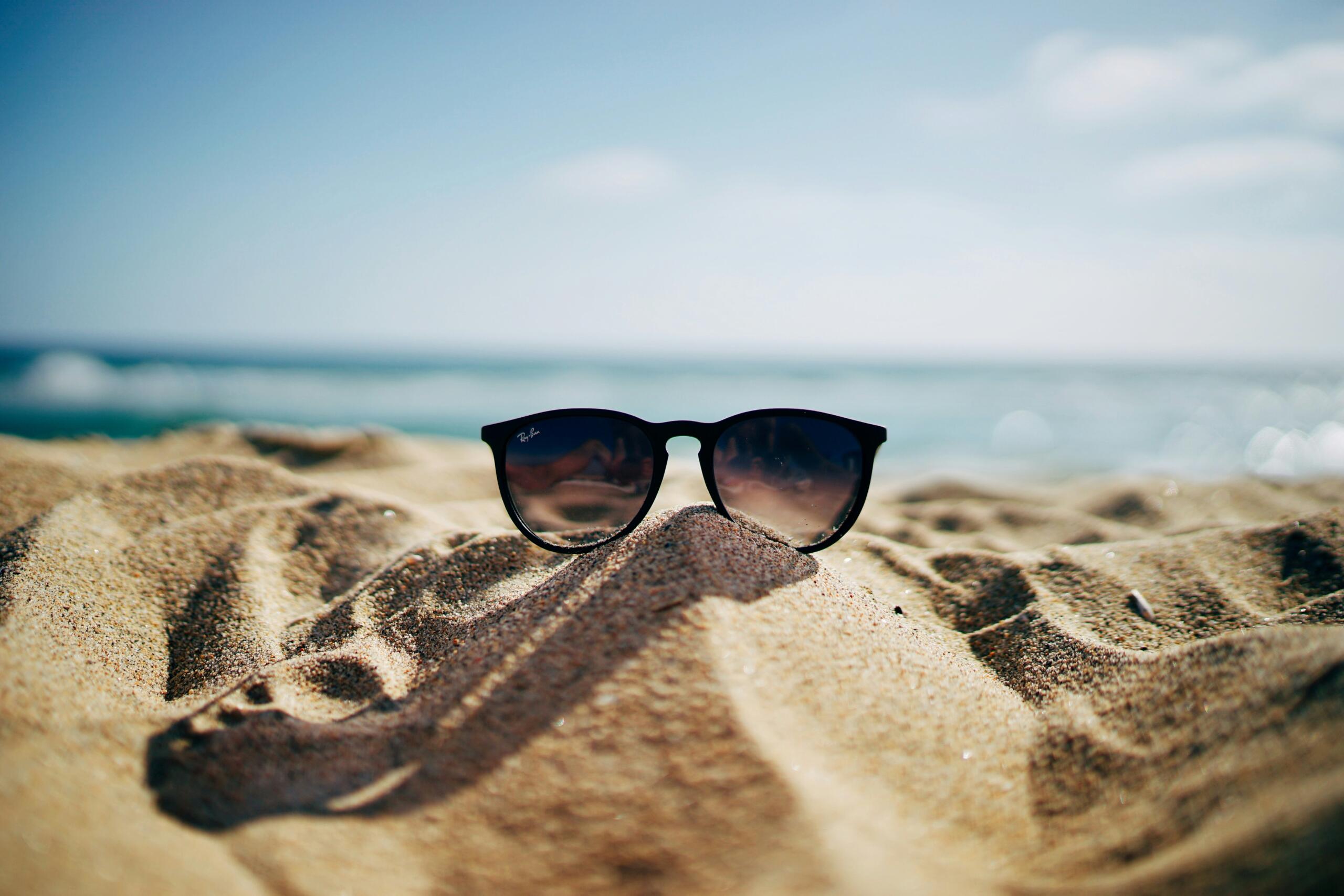 sunglasses on a sand hill at the beach