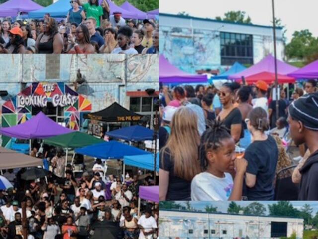 Crowd gathers at an outdoor festival with colorful tents and a mural backdrop in the background.