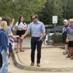 Tom Perriello greets supporters while early voting