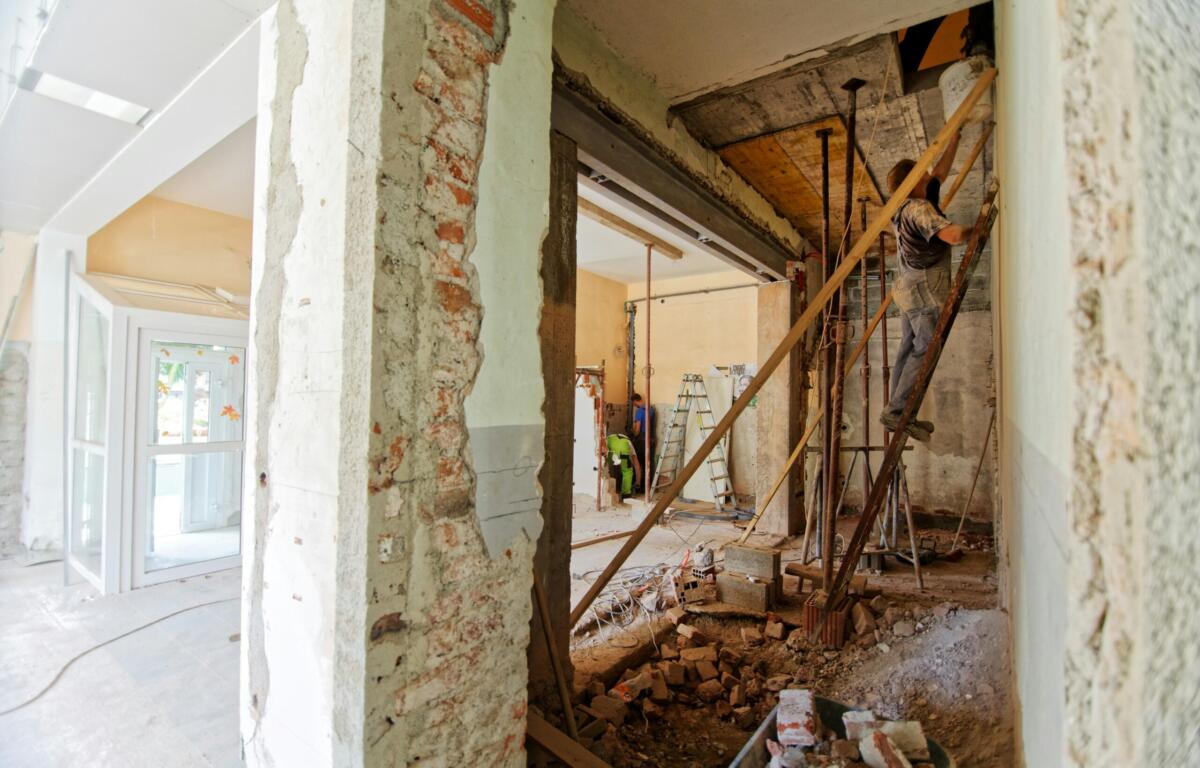 man standing on a ladder during a home renovation