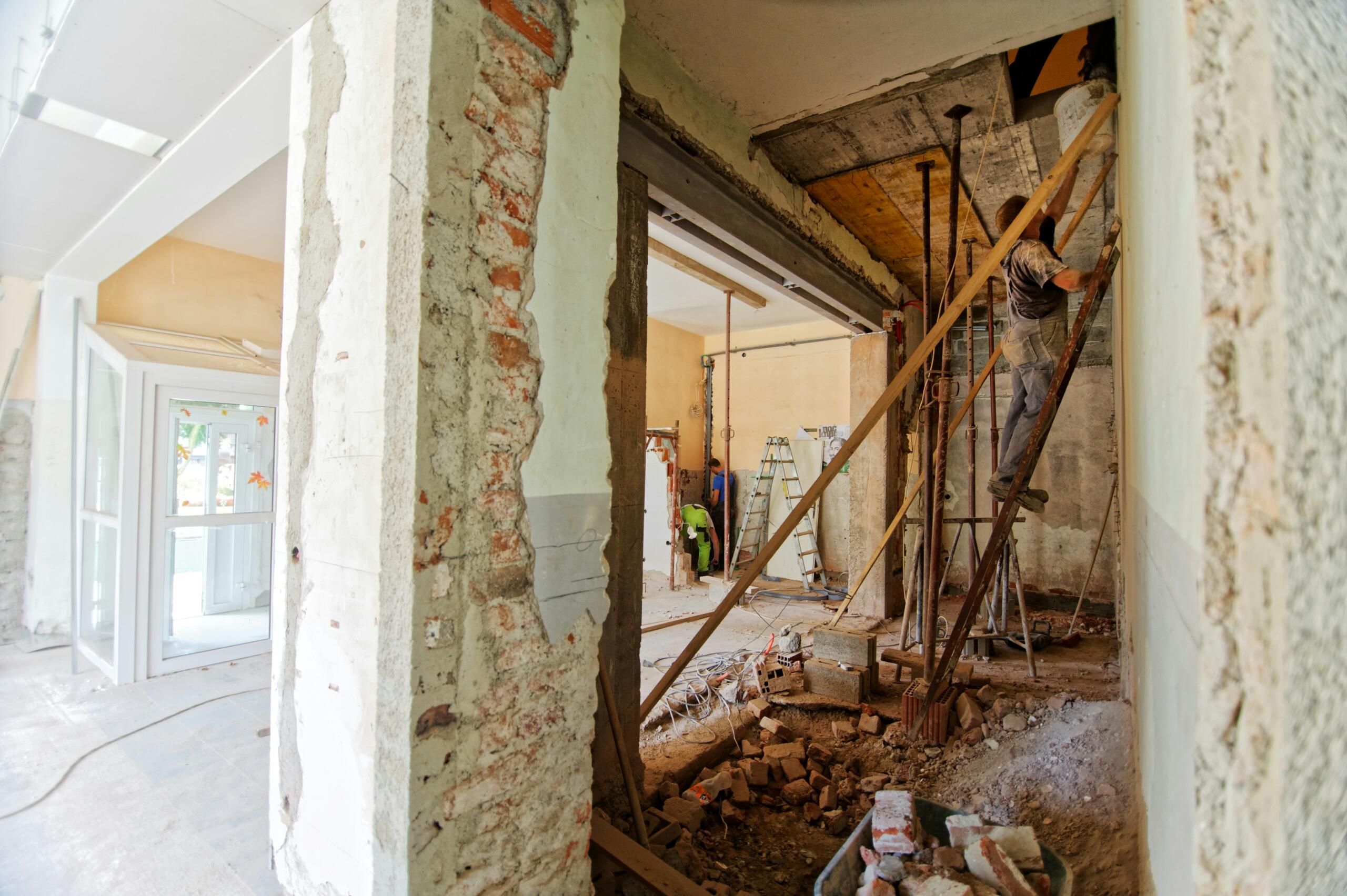 man standing on a ladder during a home renovation