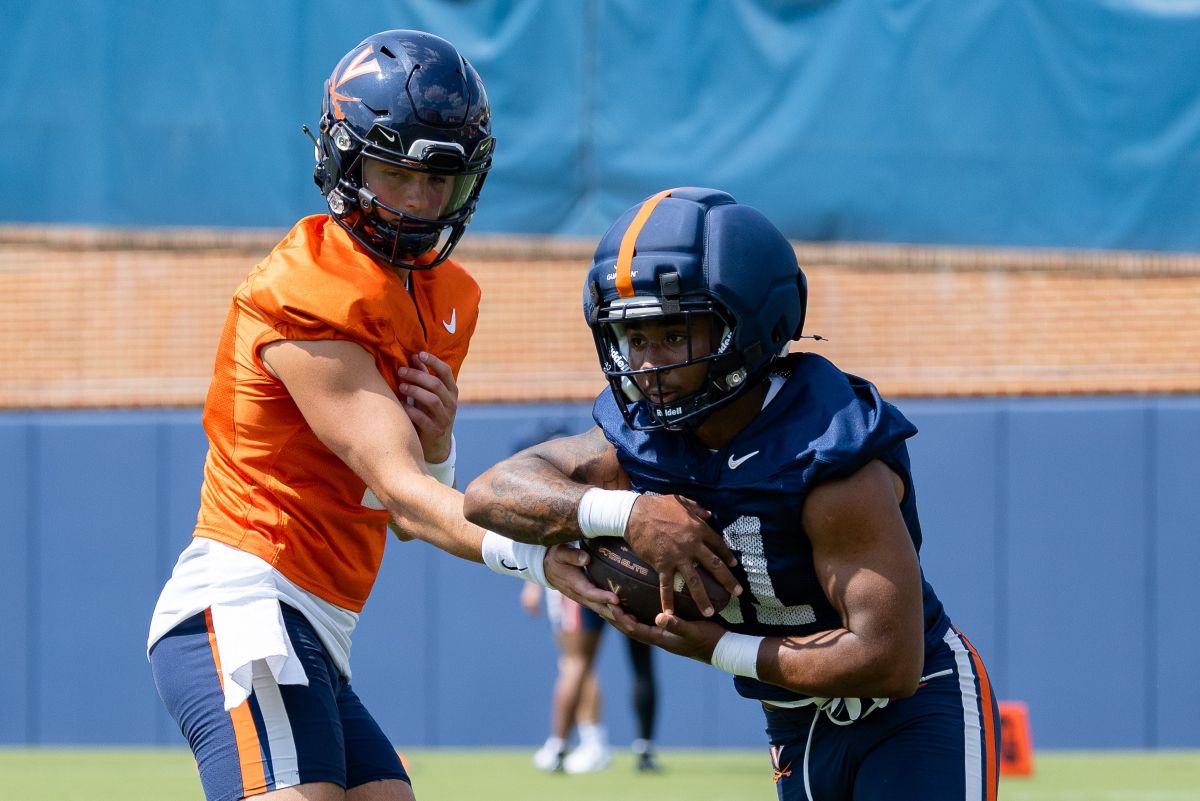 QB Beau Pribula (left) hands the ball off to RB Jekail Middlebrook (right)