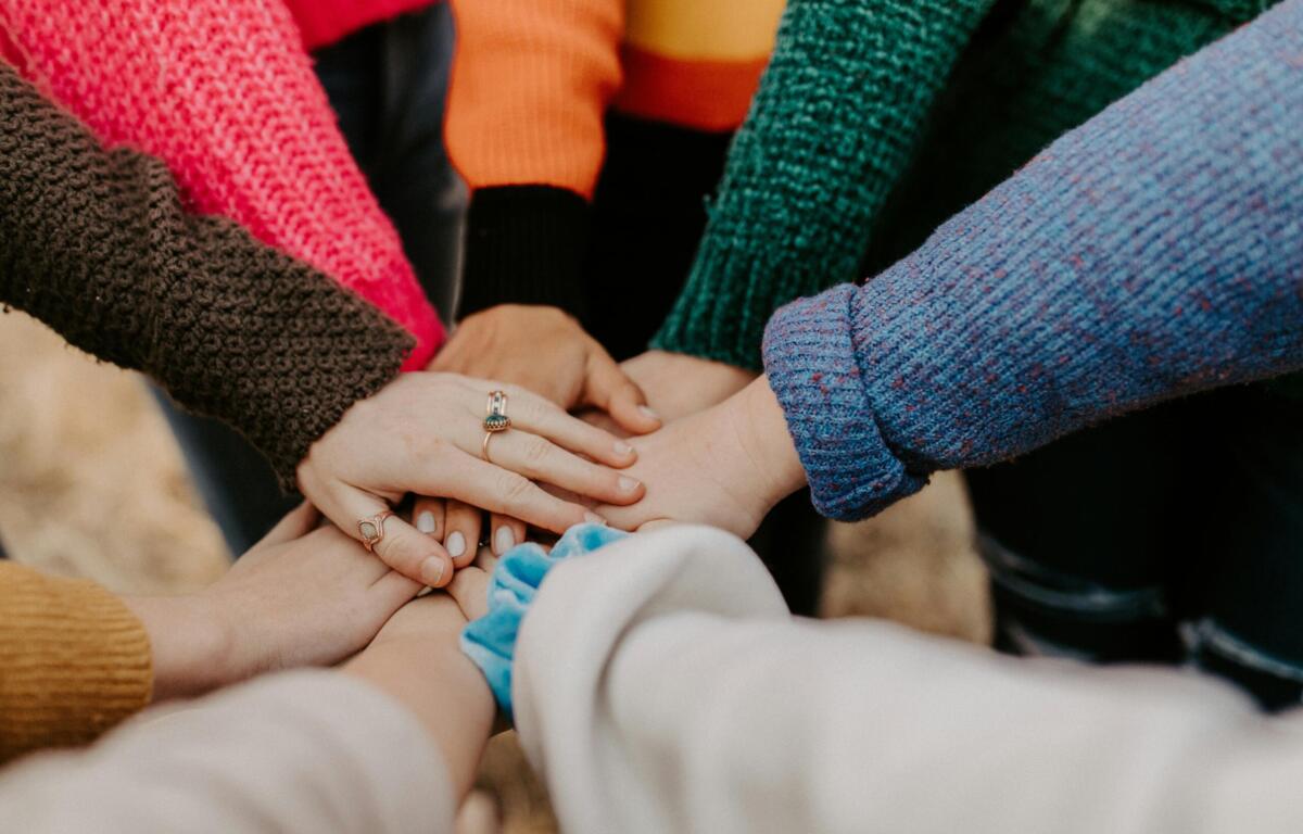 volunteers putting hands together