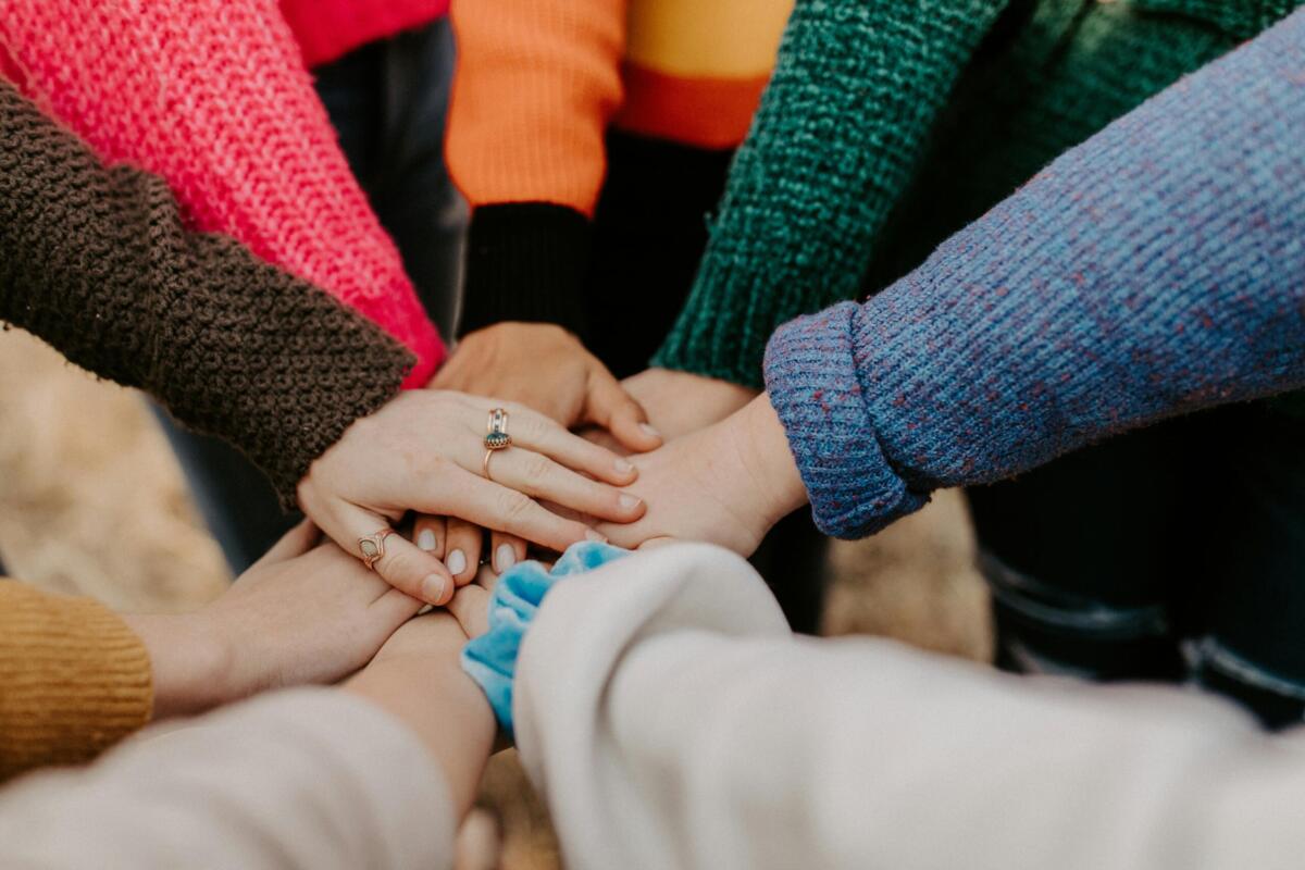 volunteers putting hands together