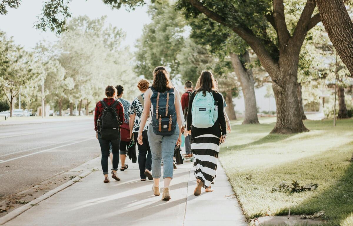 college students walking on a sidewalk