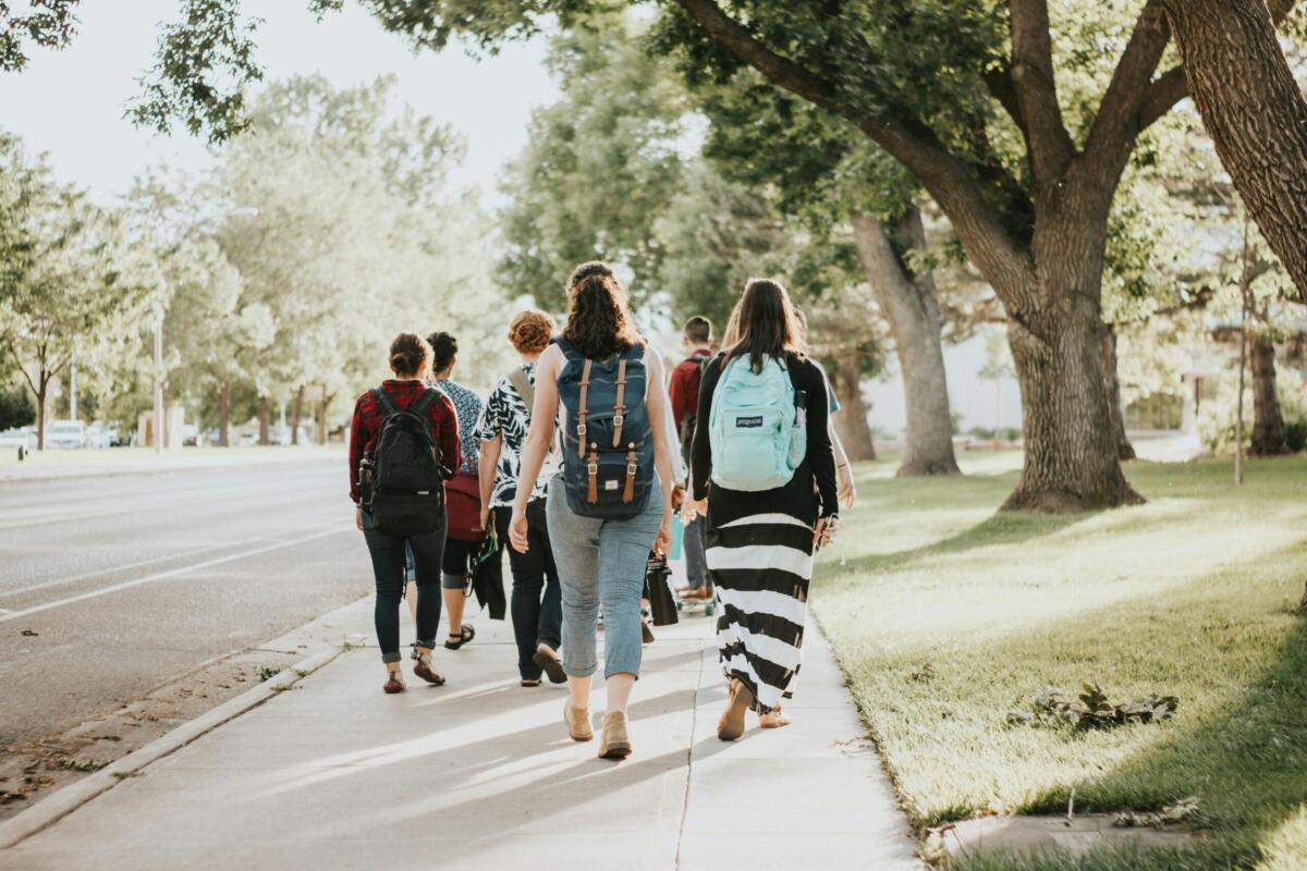 college students walking on a sidewalk