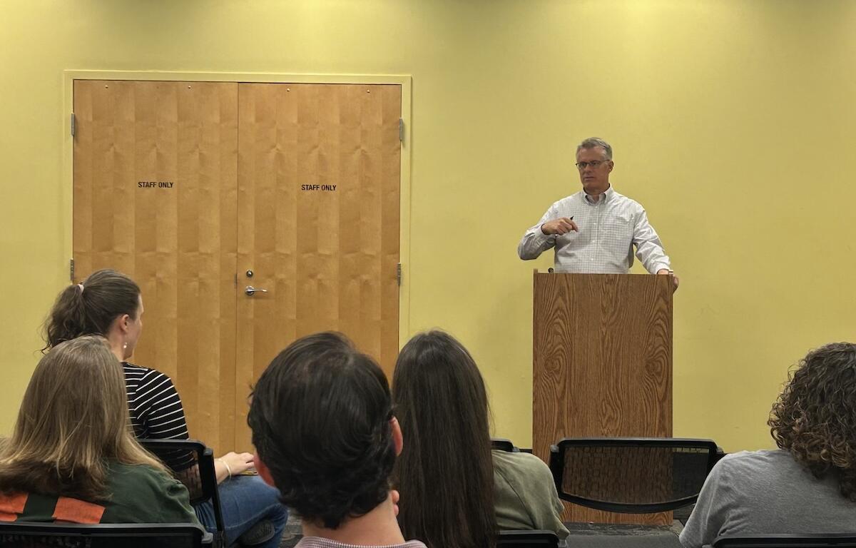 Jim Dillenbeck speaks with parents at a community town hall.