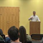 Jim Dillenbeck speaks with parents at a community town hall.