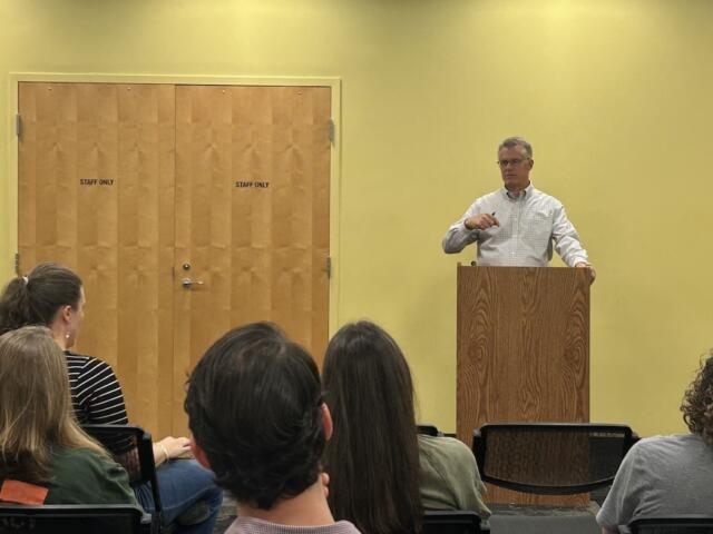 Jim Dillenbeck speaks with parents at a community town hall.