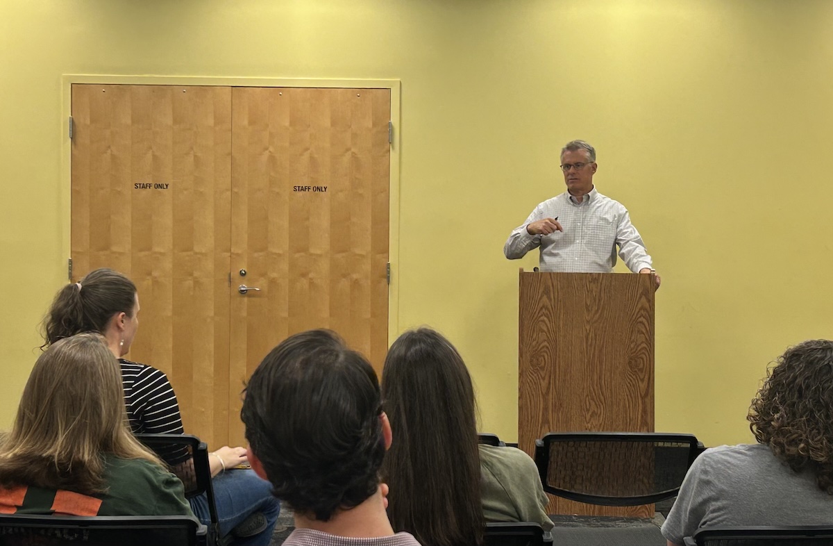 Jim Dillenbeck speaks with parents at a community town hall.