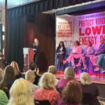 A panel of legislators hear from a concerned resident about the NextEra-Dominion merger at Hashmi's Energy Costs Listening Tour.