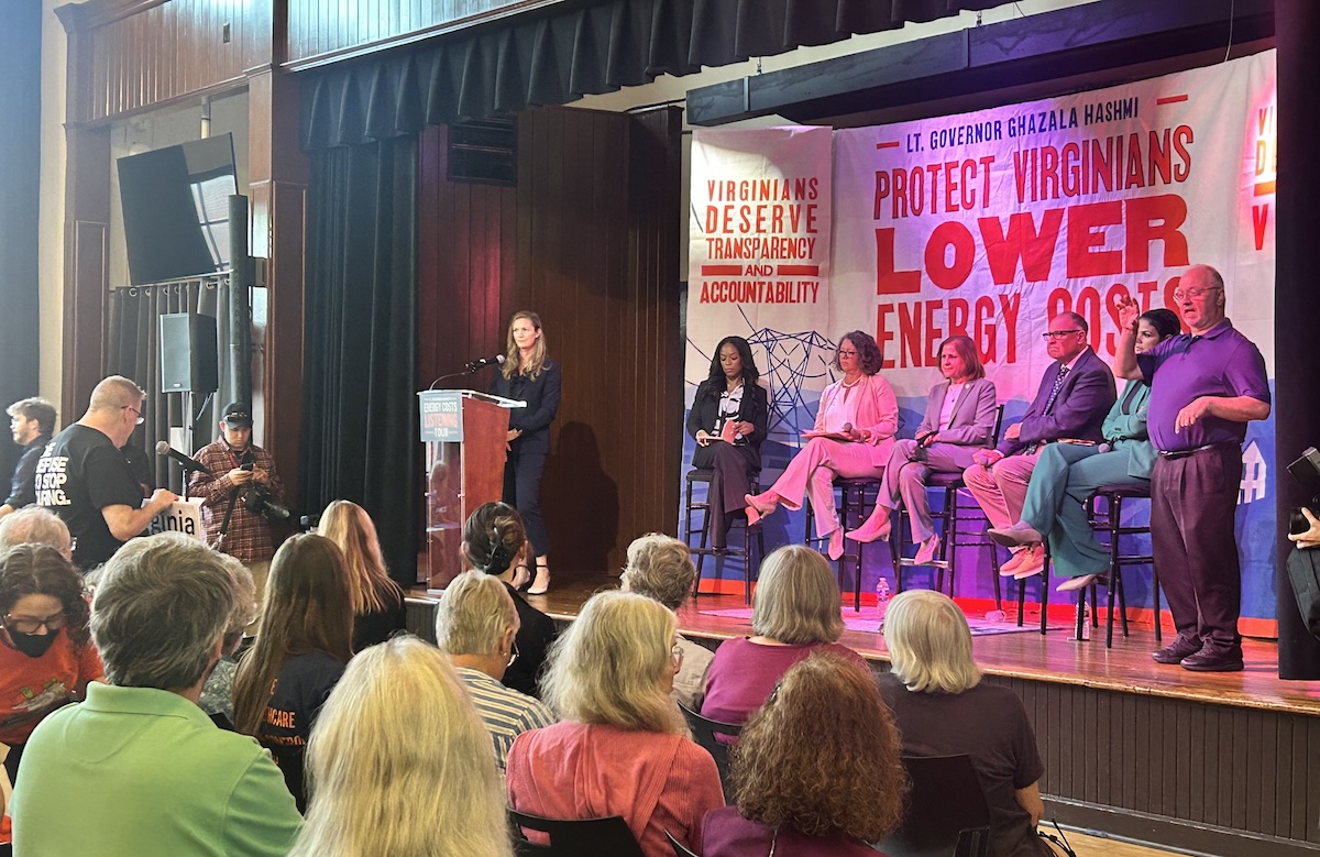 A panel of legislators hear from a concerned resident about the NextEra-Dominion merger at Hashmi's Energy Costs Listening Tour.