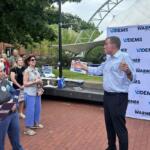 Sen. Mark Warner (right) speaks to supporters in Charlottesville.