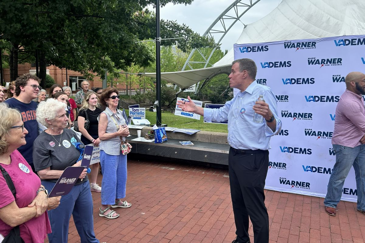 Sen. Mark Warner (right) speaks to supporters in Charlottesville.